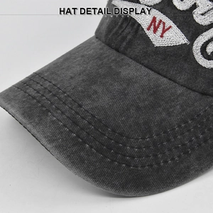 Detailed close-up of NY embroidery on gray washed vintage denim baseball cap
