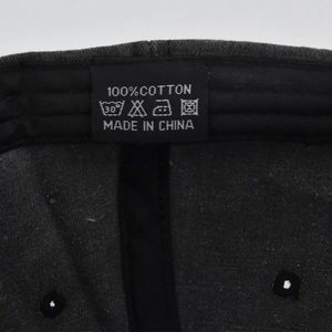 Macro detail of 100% cotton washed baseball cap showing inner label and stitching