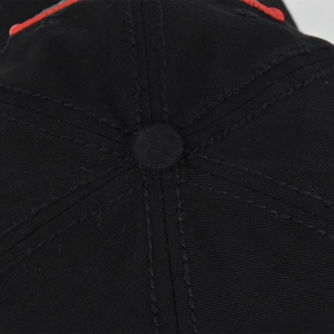 Macro shot of 3D embroidery detail and precise stitching on the crown of black baseball cap