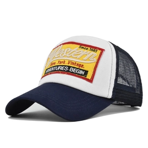 Detail showing high-quality Western 1985 embroidery on a navy and white trucker cap