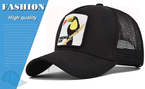 Detail of black trucker hat mesh back and toucan embroidery patch with pun slogan