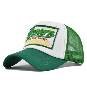 Detail showing vintage Western 1985 embroidery on green and white mesh trucker cap