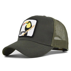 Detail of the embroidered toucan patch and breathable mesh on army green trucker hat