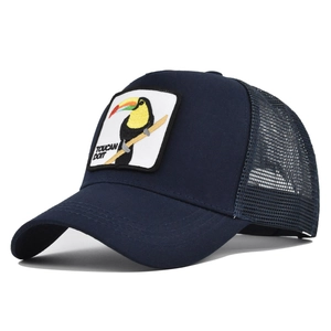 Detail of navy trucker hat featuring a white Toucan Do It embroidered patch and mesh