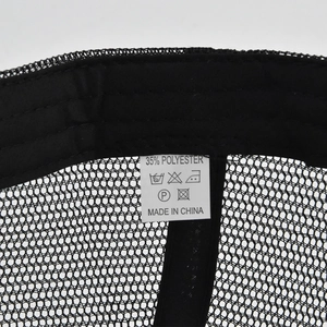 Detail of internal black mesh cap structure with white care label and stitching details
