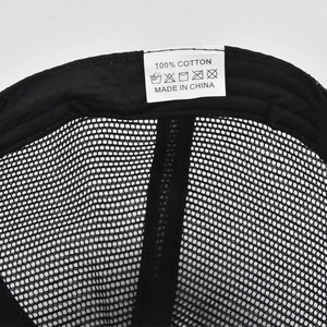Detailed macro view of the breathable mesh structure and cotton interior of the trucker hat