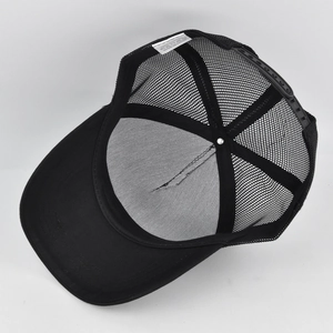Detailed interior of black mesh trucker hat showing cotton panels and adjustable snapback