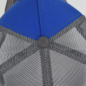 Top view of blue and grey trucker hat showing fabric stitching and breathable mesh detail