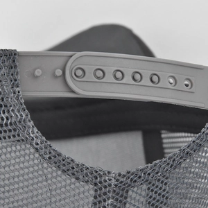 Detail view of grey mesh trucker hat showing the adjustable plastic snapback closure