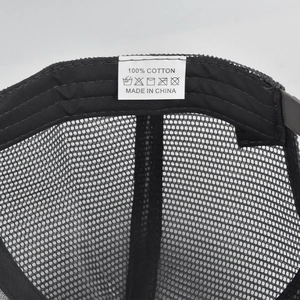 Detail view of cotton baseball cap interior featuring breathable mesh and wash care label