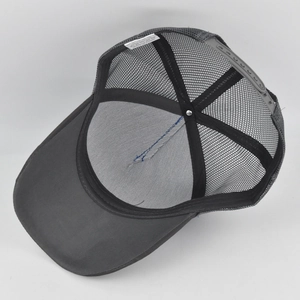 Detail view of cotton inner lining and breathable mesh back on the dark grey trucker hat