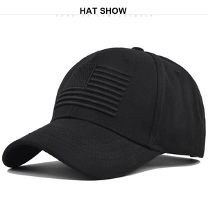 Macro detail of the 3D embroidered American flag on a black cotton baseball cap