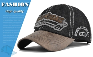 Detail of vintage baseball cap featuring distressed brown brim and 2001 side embroidery