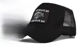 Detail view of black trucker hat featuring fish embroidery and breathable mesh back