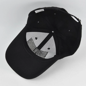 Internal view of black cotton baseball cap showing seams, eyelets and structure
