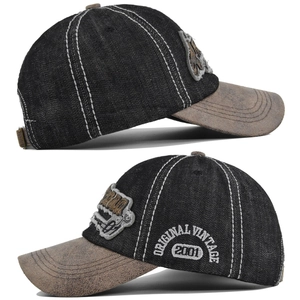 Detail of vintage baseball cap side showing 2001 embroidery and distressed denim fabric