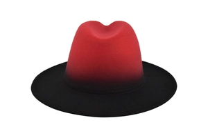 Detail of wool felt jazz fedora hat with gradient red crown and black flat brim transition