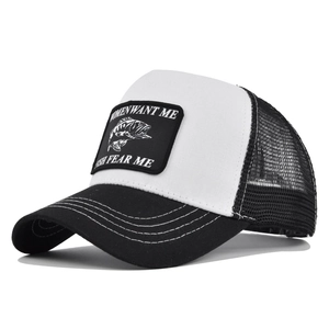 Detail of Women Want Me Fish Fear Me patch on a black and white mesh trucker cap