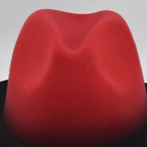 Detail shot of the red and black gradient felt texture on a vintage jazz fedora hat