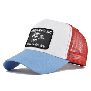 Detail of embroidered fish patch and breathable mesh on a tricolor trucker cap