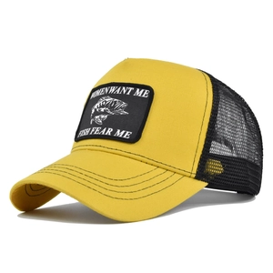 Detail of embroidered fish patch and breathable mesh on yellow and black baseball cap