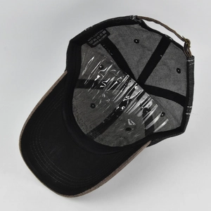 Detailed interior of washed cotton baseball cap showing 100% cotton label and metal buckle