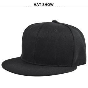 Detail view of a plain black flat-brimmed hip-hop style twill cotton baseball cap