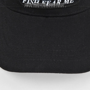 Close-up of Fish Fear Me white embroidery and stitching on black mesh baseball cap