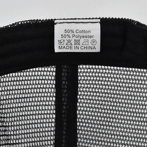 Detailed macro shot showing the 50% cotton and 50% polyester wash label inside a mesh cap
