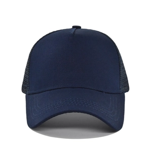 Close-up of navy blue trucker cap featuring breathable mesh back and solid front panel