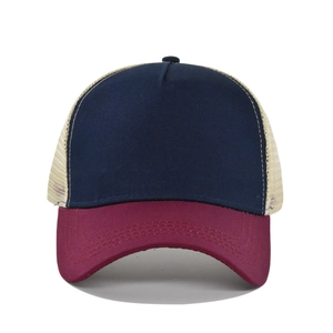 Detail view of a color-block trucker hat with navy front, burgundy brim and beige mesh back