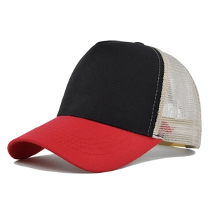 Detail view of trucker hat with black cotton front and red curved brim with mesh