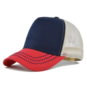Detail of navy and red baseball cap showing premium stitching and breathable mesh