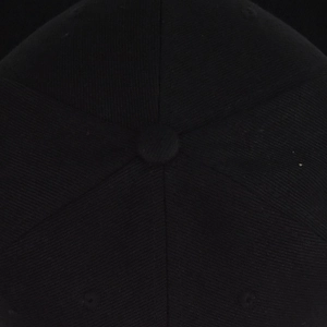 Close-up of black hip-hop baseball cap top with six panels and fabric covered button