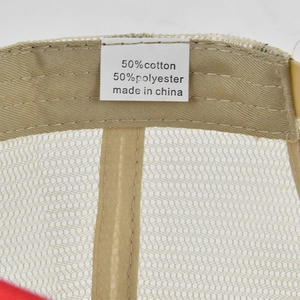 Detail view of truck hat inner tag showing 50% cotton and 50% polyester blend