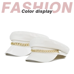 Detail of white PU leather baker boy hats featuring gold chain and silver metal button