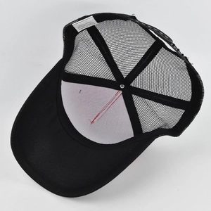 Detail showing the internal mesh structure, stitching, and adjustable strap of a black trucker hat