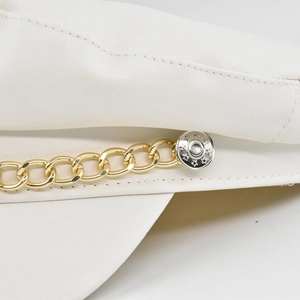 White leather newsboy cap with decorative gold chain and star engraved button detail