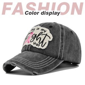 Macro detail of vintage washed cotton baseball cap with Fight embroidery and pink ribbon