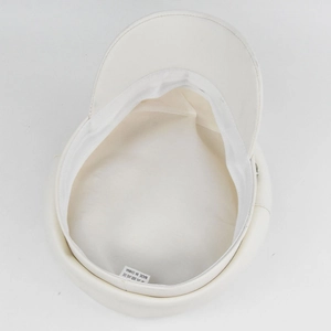 Detail of white PU leather navy hat with inner fabric lining and care label