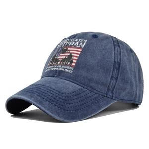 Detail of United States Veteran embroidery on navy blue washed denim baseball cap