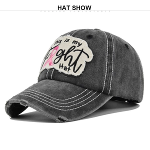 Detailed view of dark grey washed denim baseball cap with breast cancer awareness patch