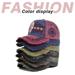 Detail of vintage washed cotton baseball caps with star embroidery and 1985 badges