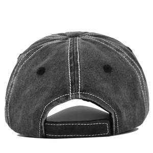 Detail view of washed denim baseball cap with contrast stitching and adjustable strap