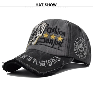 Detail of vintage washed baseball cap with skull embroidery and distressed brim details