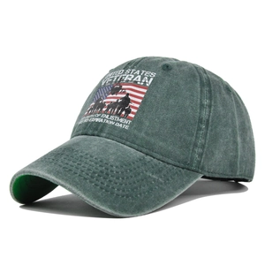 Detailed view of veteran theme embroidery and distressed fabric on a green baseball cap