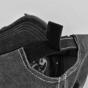 Detail of adjustable velcro strap and white stitching on vintage grey cotton baseball cap