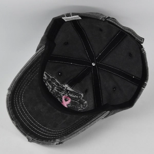 Detail view of cotton baseball cap interior showing stitching and pink ribbon embroidery
