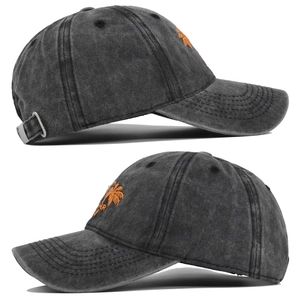 Close-up of washed dark gray baseball cap with orange palm tree embroidery and metal buckle