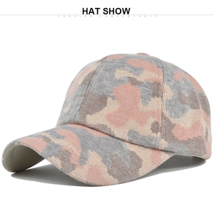 Detail view of pink and grey camo knitted fabric on a ponytail baseball cap